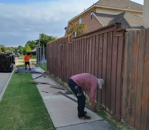 Workers removing old fence