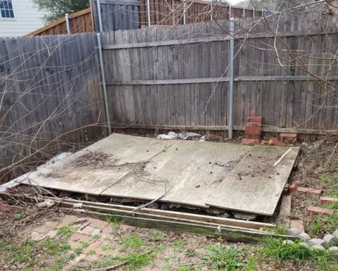 pile of lumber and other debris and junk in a yard